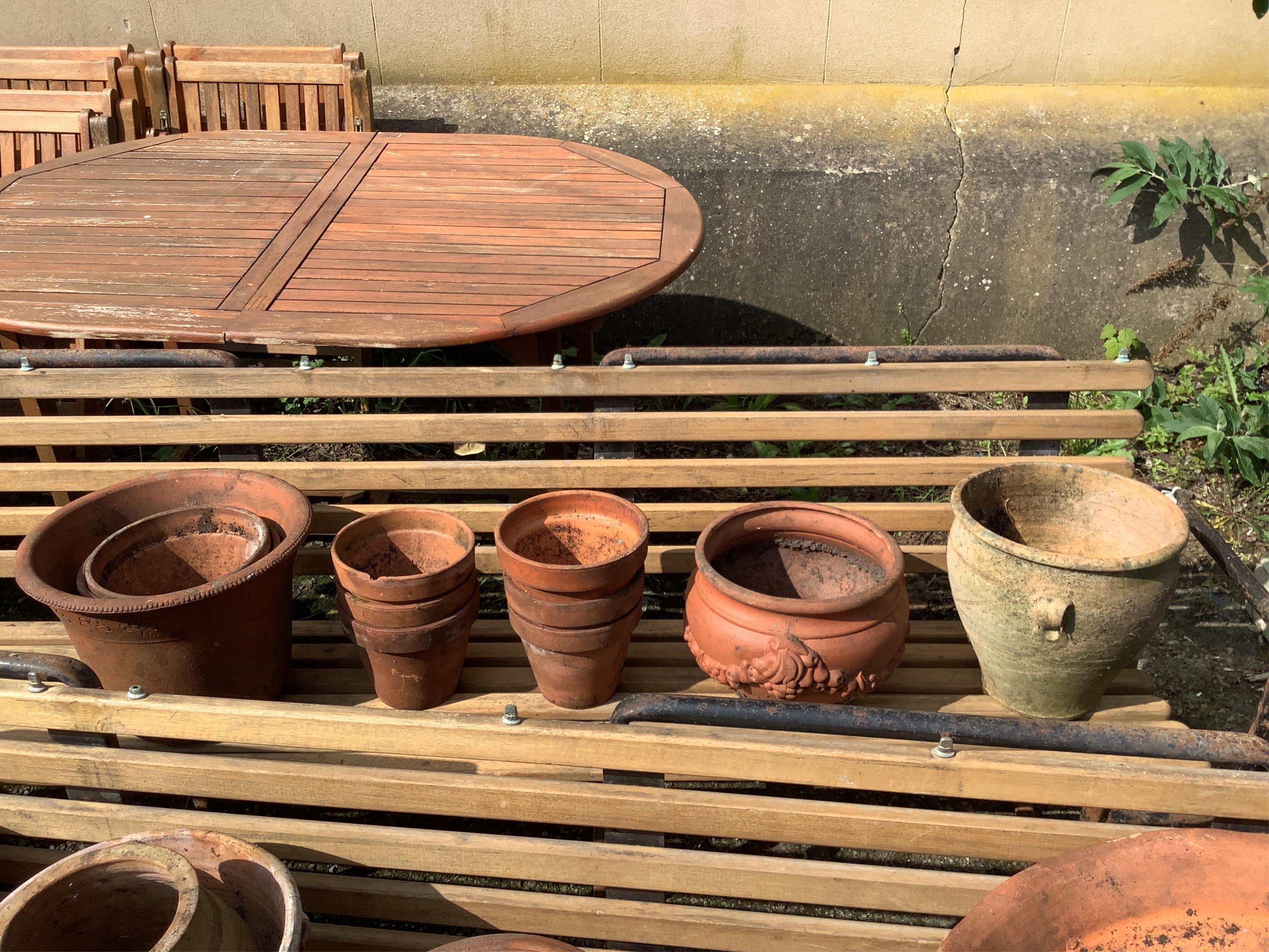 Twenty-one assorted terracotta garden planters, largest diameter 38cm, height 28cm